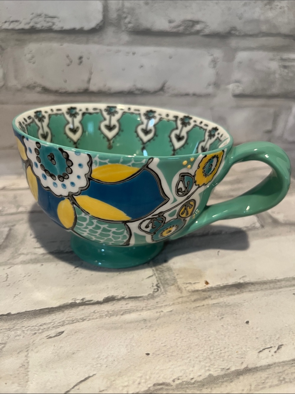 Anthropologie Turquoise Ceramic coffee Mug Blue and Yellow Floral Motif 10 oz